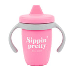 Bella Tunno Pink sippy cup with 'Sippin' pretty' text on a white background. Available at Be Charmed
