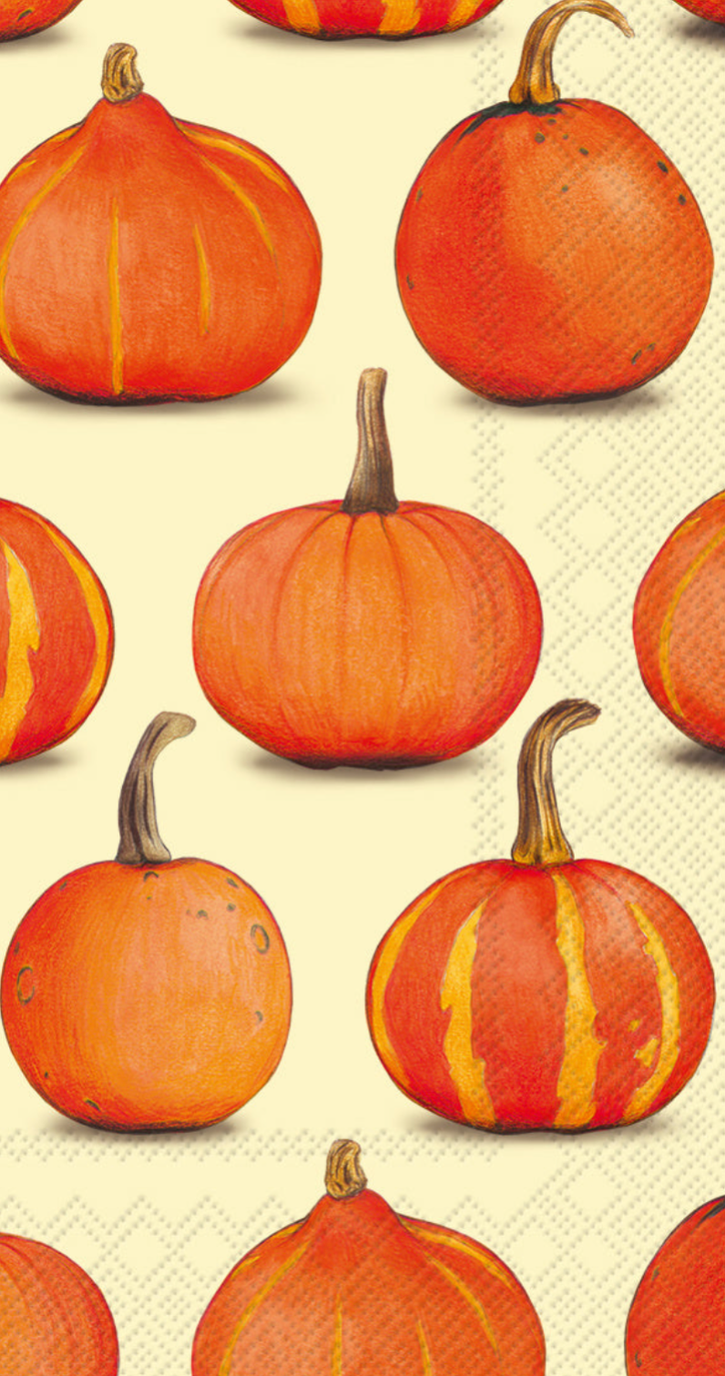 A Boston International guest towel with a repeating pattern of illustrated orange pumpkins with brown stems on a pale cream background with a subtle geometric texture. Available at Be Charmed