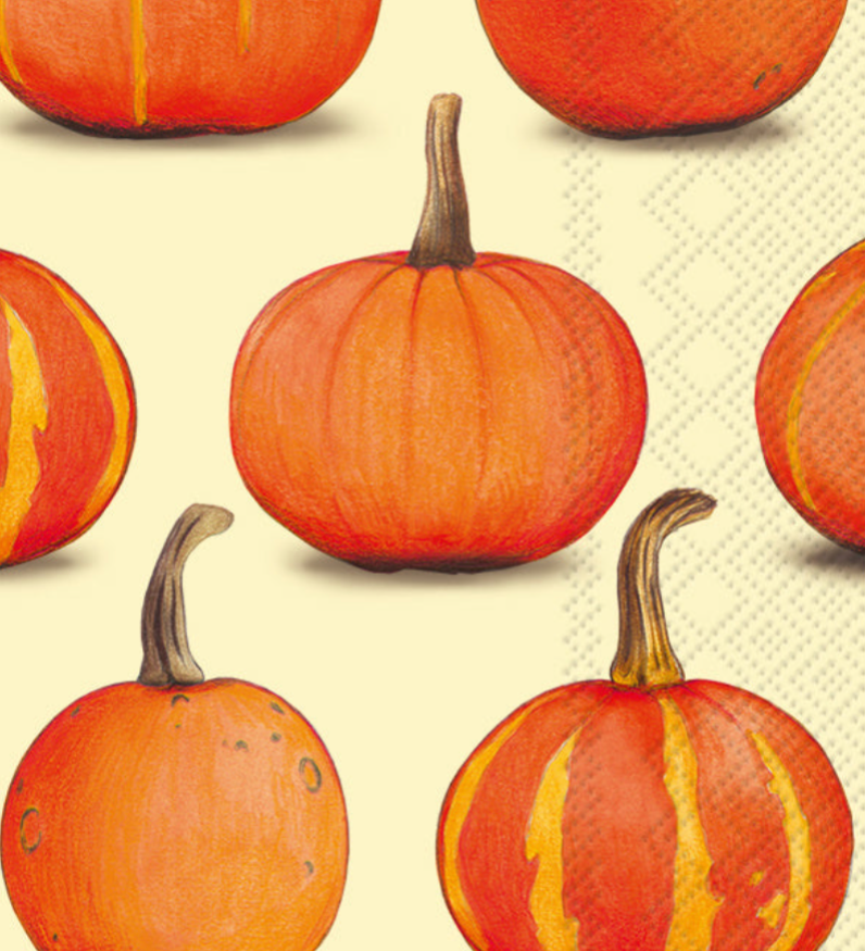 A Boston International guest towel with a repeating pattern of illustrated orange pumpkins with brown stems on a pale cream background with a subtle geometric texture. Available at Be Charmed