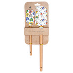 Two wooden-handled silicone spatulas with colorful footballl-themed silicone heads, displayed on a brown kraft cardboard hanger against a white background. Available at Be Charmed