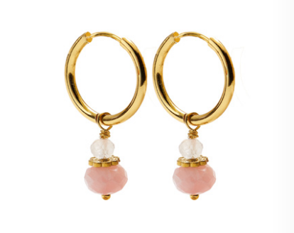 A pair of CAI gold hoop earrings with small pink opal stone beads dangling below, shown on a plain white background. Available at Be Charmed