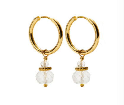 A pair of CAI gold hoop earrings with small white quartz stone beads dangling below, shown on a plain white background. Available at Be Charmed