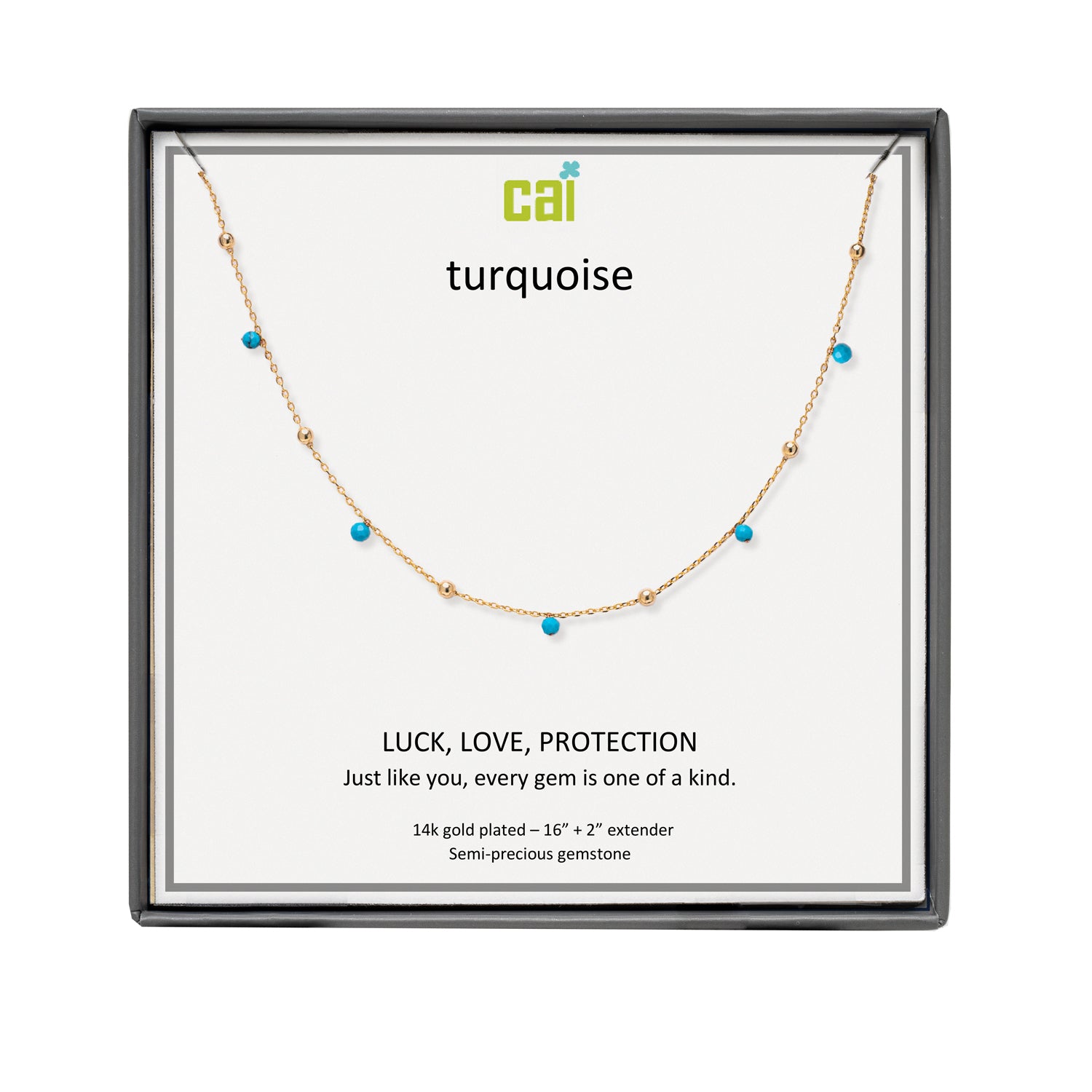 A CAI gold-plated necklace with small turquoise gemstones displayed on a branded white card inside a black presentation box. The card reads 'cai turquoise' and 'LUCK, LOVE, PROTECTION'. Available at Be Charmed