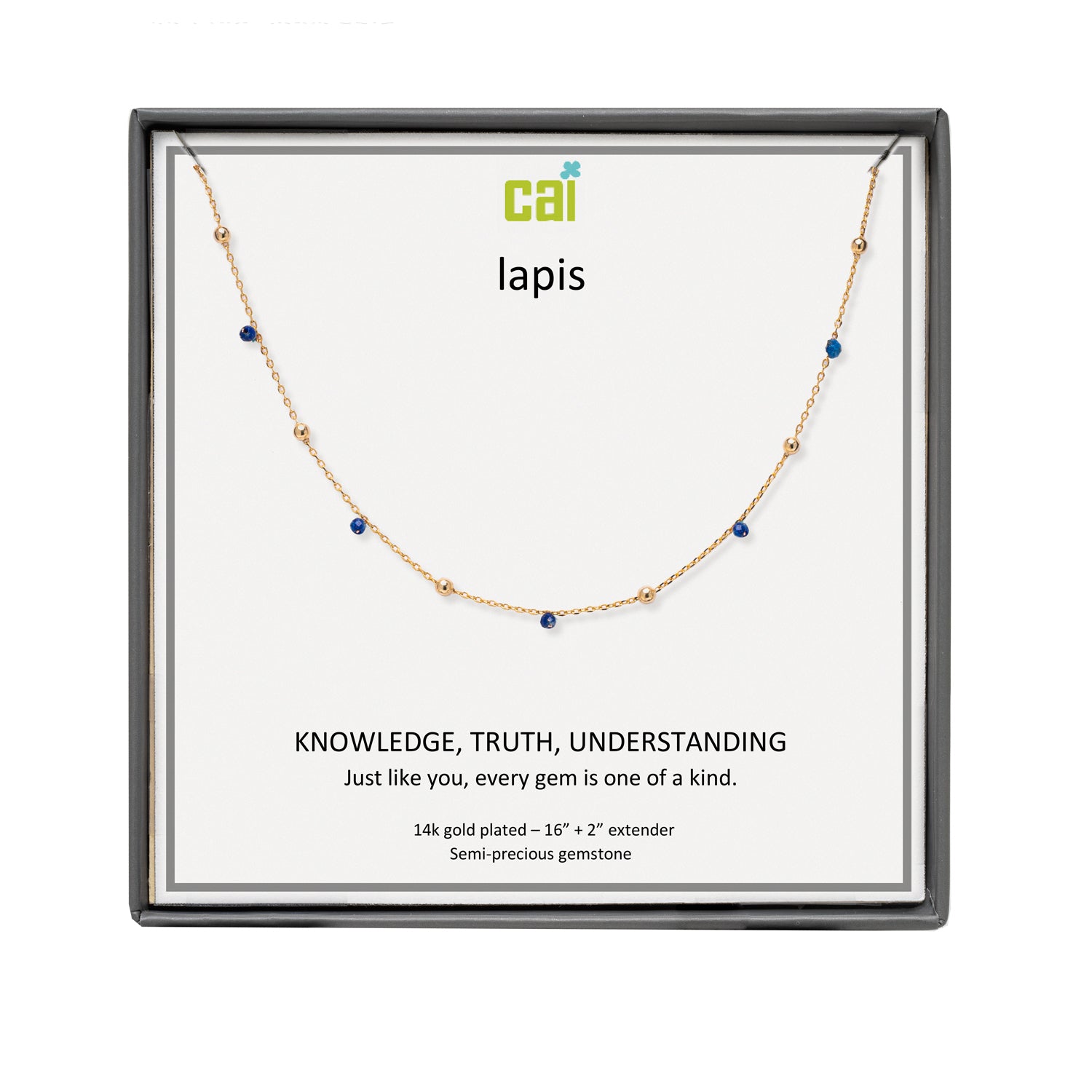 A CAI gold-plated lapis necklace with small blue gemstones, presented in a square black gift box with a white insert card. The card features the brand logo 'cai' and the word 'lapis' along with a quote. Available at Be Charmed