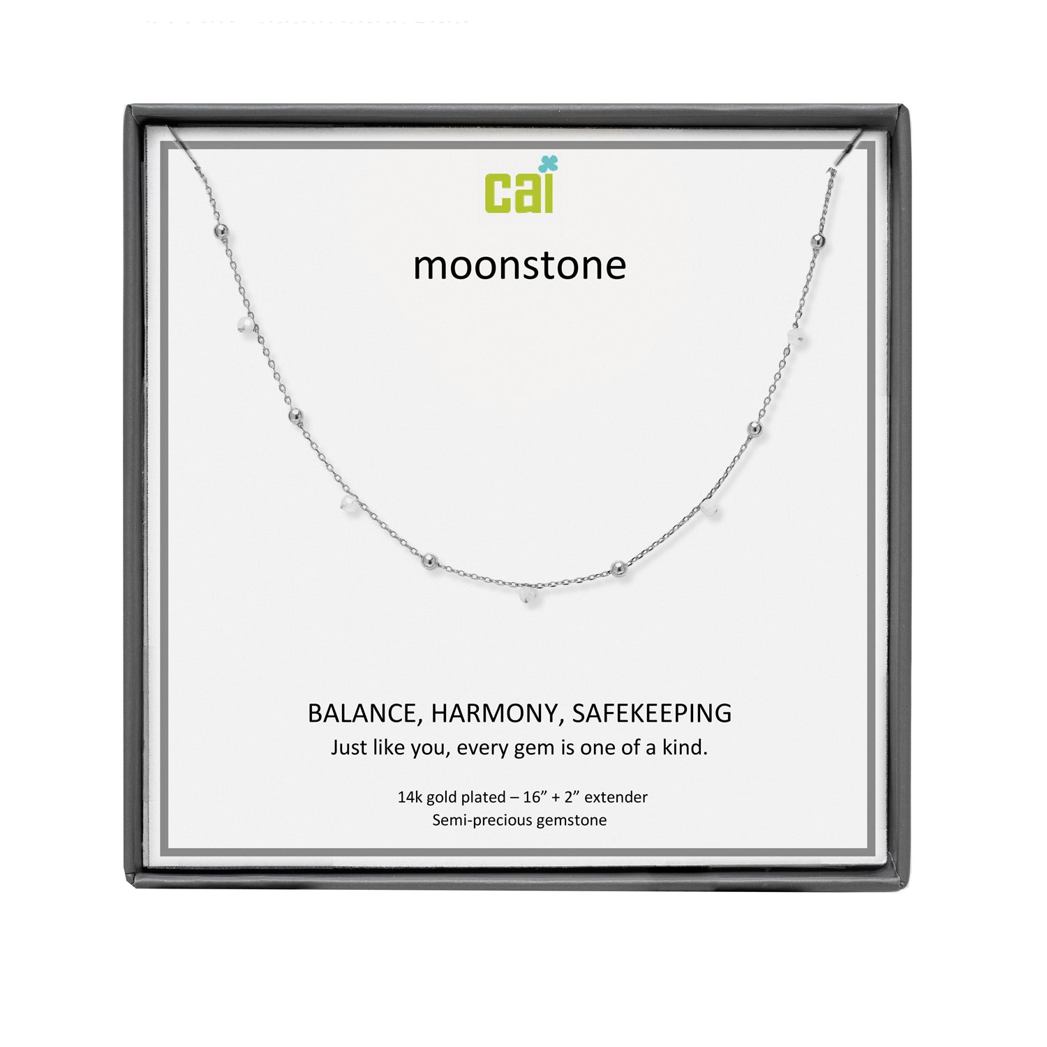 A CAI silver necklace with small spaced beads displayed on a white card inside a square black gift box. The card shows the brand name 'cai' and the product name 'moonstone', along with descriptive text. Available at Be Charmed