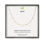 A CAI gold-plated pearl necklace with a delicate chain and small spaced pearls, presented in a square black gift box on a white backing card. The card features the brand logo 'cai' and the word 'pearl' along with product details. Available at Be Charmed