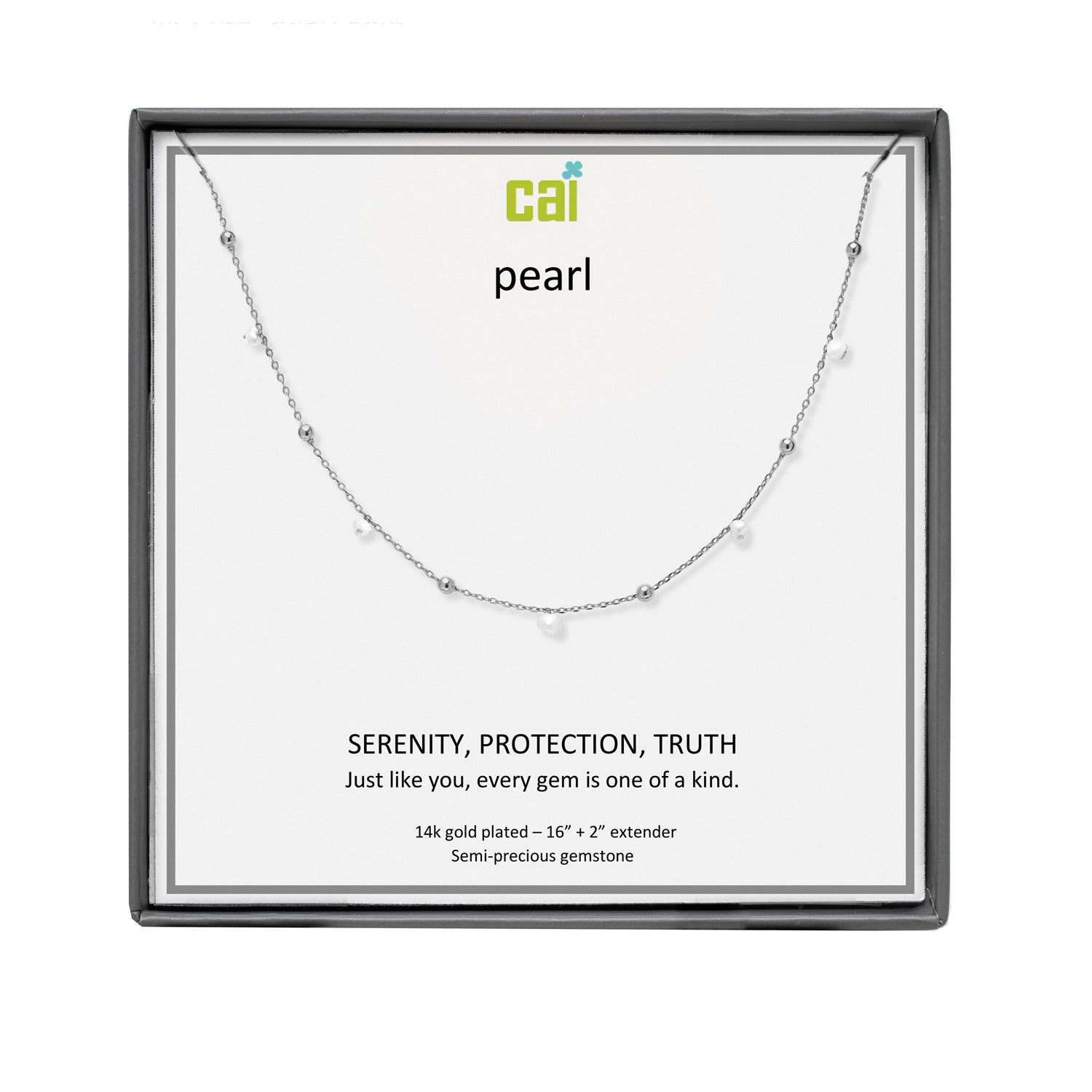 A CAI silver necklace with tiny pearl-like beads and small clear gemstones, displayed on a white card inside a square black gift box. The card reads 'cai pearl' and 'SERENITY, PROTECTION, TRUTH'. Available at Be Charmed