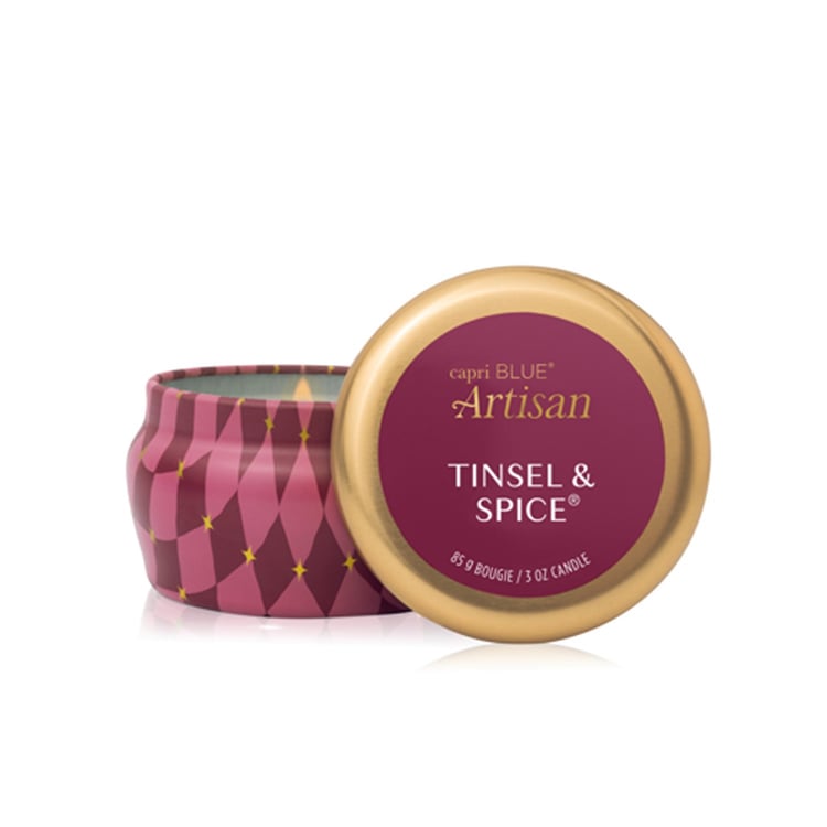Capri Blue Artisan Tinsel & Spice mini tin candle with gold lid on a white background. Available at Be Charmed
