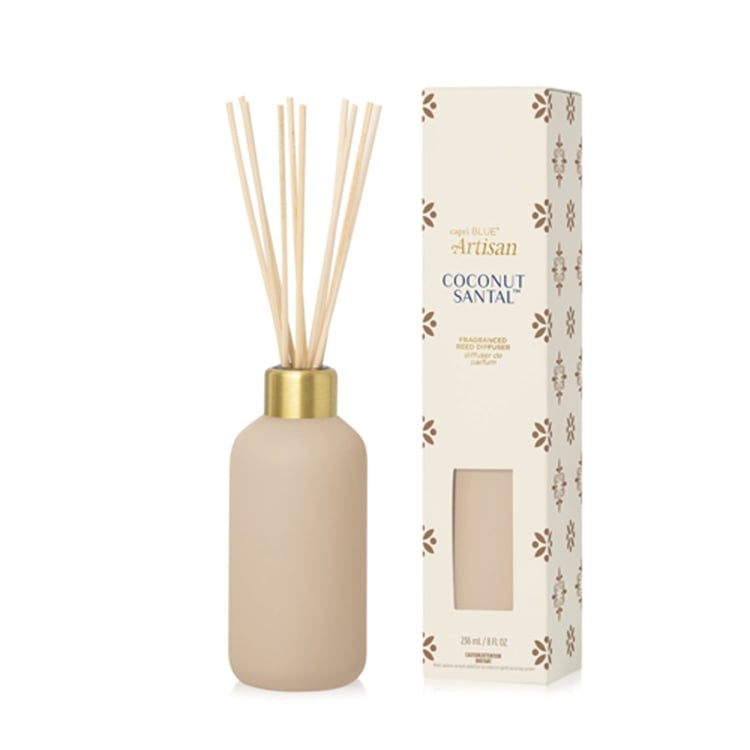 Capri BLue beige diffuser bottle with gold cap and decorative packaging on a white background. Available at Be Charmed