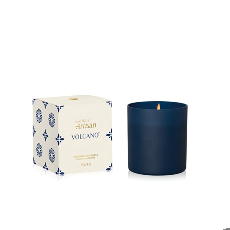 Capri Blue candle with 'Artisan Volcano' packaging on a white background. Available at Be Charmed