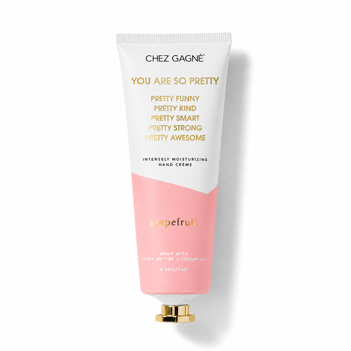 Chez Gagné 'You Are So Pretty' hand cream in a squeeze tube with a white and pink color-blocked design and gold lettering, set against a plain white background. Available at Be Charmed