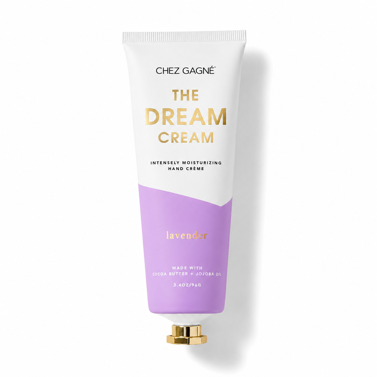 A squeeze tube of Chez Gagnée 'The Dream Cream' hand cream, featuring a white upper half with gold lettering and a lavender purple lower half, complete with a gold cap, set against a clean white background with a soft shadow. Available at Be Charmed