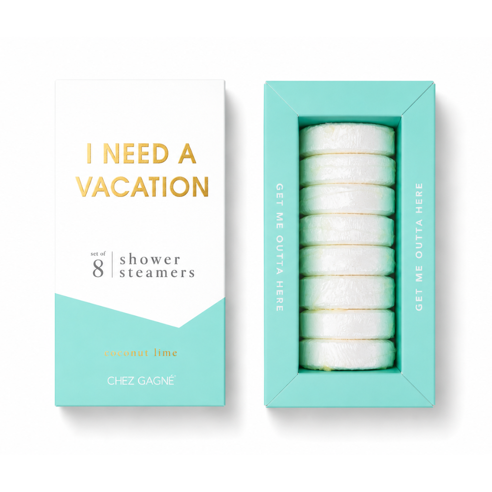 Chez Gagné 'I Need A Vacation' coconut lime shower steamers set, featuring a white and mint green outer box next to its open window display showing eight round white steamers inside a matching mint green tray. Available at Be Charmed