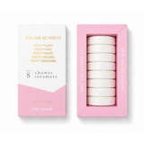 Chez Gagné You are so Pretty set of 8 shower steamers in a pink box, shown next to the outer packaging on a white background. Available at Be Charmed