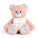 Demdaco Plush teddy bear with a gymnastics-themed bracelet on a white background. Available at Be Charmed