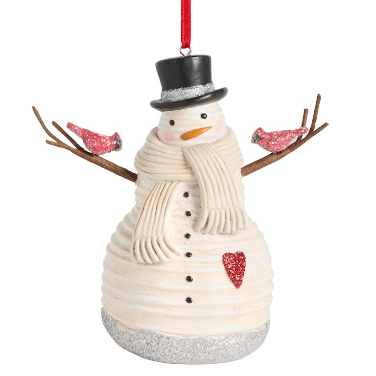 A festive Demdaco snowman Christmas ornament with a cream-colored textured body, black top hat with silver glitter trim, a cream scarf, brown twig arms, two red glitter birds, and a red hanging ribbon. Available at Be Charmed