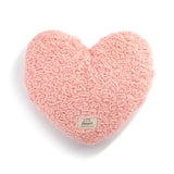 Demdaco weighted coral heart-shaped pillow on a white background. Available at Be Charmed