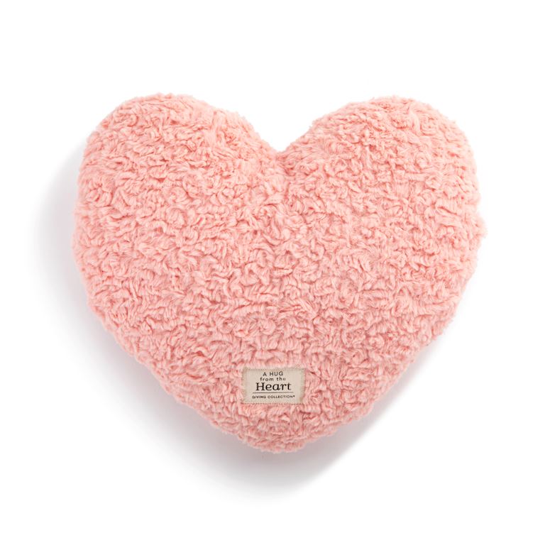 Demdaco weighted coral heart-shaped pillow on a white background. Available at Be Charmed