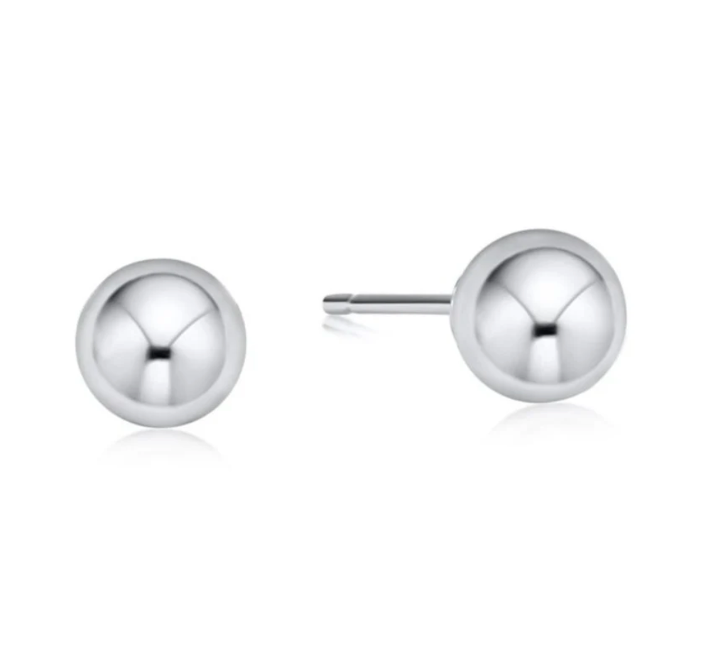 Pair of enewton silver stud earrings on a white background. Available at Be Charmed