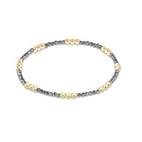 Silver faceted hematite enewton Joy 2mm bracelet featuring gold-filled beads with a colorful accent available at Be Charmed