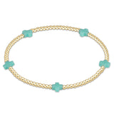 enewton gold-filled elastic bracelet with small mint green beads, featuring a signature cross design. Available at Be Charmed
