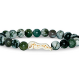 A beaded stretch Fahlo  bracelet featuring round green and white marbled beads, with a central cheetah charm, set against a plain white background. Available at Be Charmed