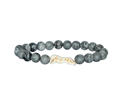 A beaded stretch Fahlo bracelet featuring dark gray and black marbled round beads with a small cheetah charm in the center, set against a plain white background. Available at Be Charmed