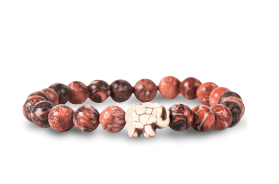 A beaded stretch fahlo bracelet made of round reddish-brown and black marbled beads with a small carved off-white elephant charm in the center, shown on a white background. Available at Be Charmed