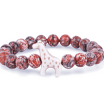 A beaded stretch Fahlo bracelet featuring round reddish-brown and white marbled beads with a small white giraffe charm in the center, set against a plain white background. Available at Be Charmed