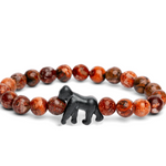 A beaded stretchFahlo  bracelet featuring round brown and reddish-brown marbled beads with a small black gorilla charm at the center, displayed on a clean white background. Available at Be Charmed