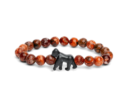 A beaded stretchFahlo  bracelet featuring round brown and reddish-brown marbled beads with a small black gorilla charm at the center, displayed on a clean white background. Available at Be Charmed