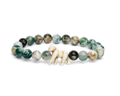A beaded stretch Fahlo bracelet featuring round green, white, and gray marbled beads, with a small gorilla charm at the front center, displayed on a clean white background. Available at Be Charmed