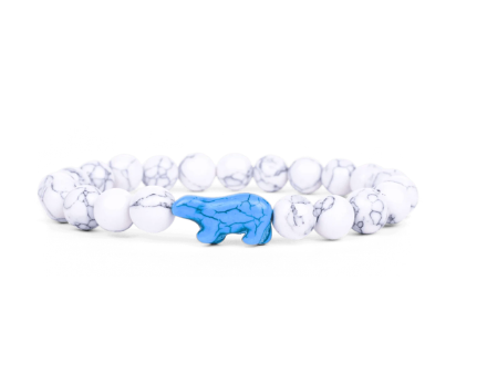 A beaded stretch Fahlo bracelet featuring white and gray marbled beads with a central blue polar bear charm, shown on a plain white background. Available at Be Charmed