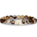 A beaded stretch Fahlo bracelet featuring marbled brown, cream, and white beads, with a red panda charm, displayed on a clean white background. Available at Be Charmed