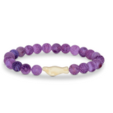 A beaded stretch Fahlo bracelet featuring round purple marbled beads and a central cream-colored bone-shaped seal bead, displayed on a clean white background. Available at Be Charmed