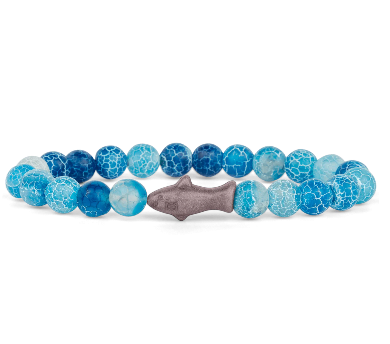A beaded stretch Fahlo bracelet featuring textured blue and light blue marbled beads, with a central gray shark charm, displayed on a clean white background. Available at Be Charmed