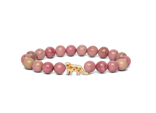 A beaded stretch Fahlo bracelet featuring round pinkish-red beads with one snow leopard charm, displayed on a clean white background. Available at Be Charmed