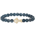 A beaded stretch Fahlo bracelet featuring dark blue-gray marbled round beads and a central cream-colored whale shark, shown on a plain white background. Available at Be Charmed