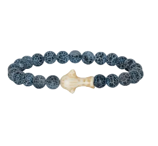 A beaded stretch Fahlo bracelet featuring dark blue-gray marbled round beads and a central cream-colored whale shark, shown on a plain white background. Available at Be Charmed
