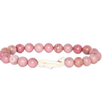 A pink beaded Fahlo bracelet with round pink stone beads and a small white whale-shaped charm, shown on a plain white background. Available at Be Charmed