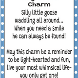 A charm card or print with a white center, black text reading 'Silly Goose Charm' and a humorous goose quote, framed by a blue-and-white polka dot border. The brand name GANZ appears at the bottom. Available at Be Charmed