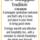 A white card with a thin yellow border, featuring black text that reads 'the Pineapple Tradition CHARM' and a quote about pineapple symbolism and warmth, signed '-a.s. Available at Be Charmed