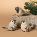 Three decorative bird figurines on a wooden block with a beige background. Available at Be Charmed