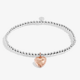 A Littles & Co Birthday Love silver and rose gold bracelet featuring a delicate mixed-metal charm on a beaded band, available at Be Charmed