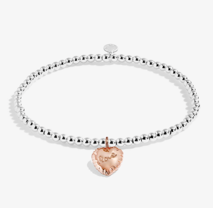 A Littles & Co Birthday Love silver and rose gold bracelet featuring a delicate mixed-metal charm on a beaded band, available at Be Charmed