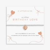 A littletes & Co. rose gold bracelet with a heart-shaped charm, displayed on its white gift card with birthday-themed text and illustrations. Available at Be Charmed