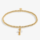 A Littles & Co Birthday Wish gold bracelet featuring a delicate gold charm on a beaded band, available at Be Charmed