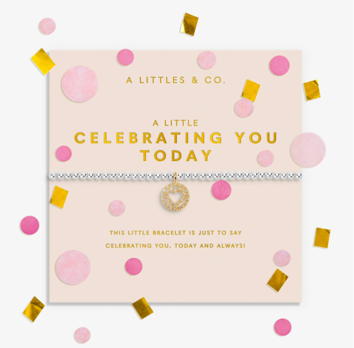 A silver-toned bracelet with a gold star charm and a delicate chain, presented on a light pink branded card. The card is decorated with pink circles, gold confetti, and gold foil text reading 'A LITTLES & CO. Available at Be Charmed