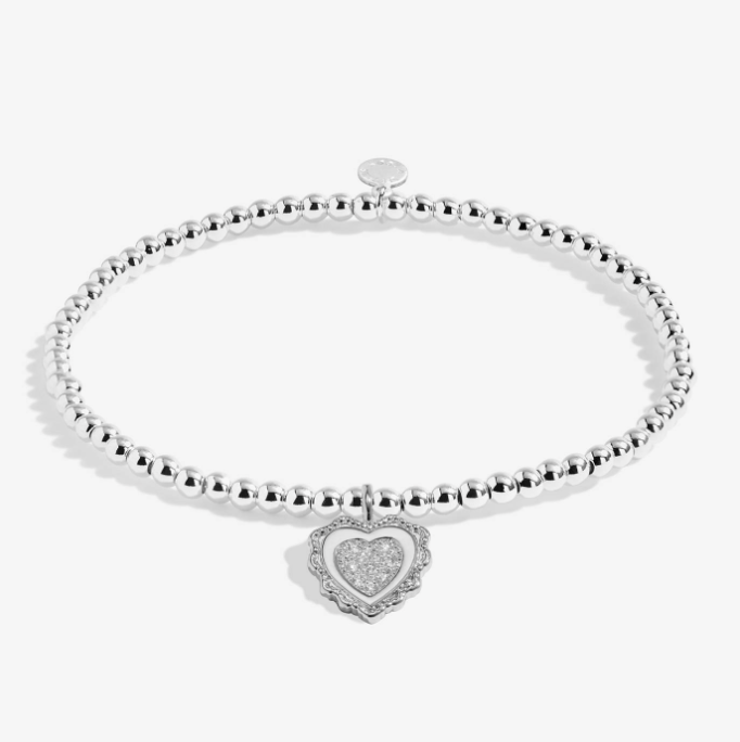 A Littles & Co Family Is The Heart Of Christmas silver bracelet featuring a holiday charm on a beaded band, available at Be Charmed