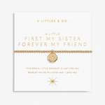 A gold chain bracelet with a central octagonal gold charm set with a clear crystal, displayed on a white card with gold lettering from the brand A LITTLES & CO. Available at Be charmed